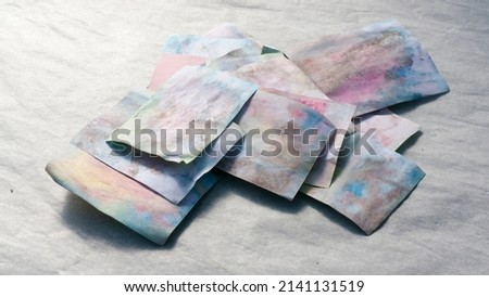 Pieces of paper with washed out color stains