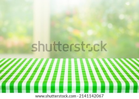 Green checkered tablecloth texture top view with abstract green from garden background.For montage product display or design key visual layout.