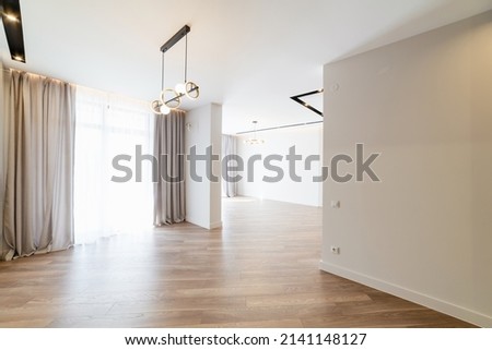 white interior in a new house with large windows and floors