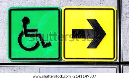 Disabled handicap icon and arrow on the wall. Wheelchair symbol