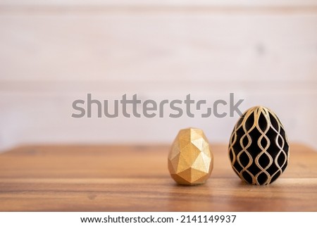 Trendy Easter low poly decor. Golden and black eggs of geometric style. Happy Easter greeting card. Holiday concept in minimal style