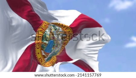The state flag of Florida waving in the wind. Florida is a state located in the Southeastern region of the United States. Democracy and independence.