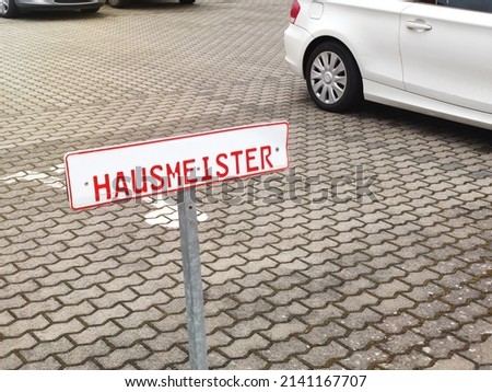 An image of a caretaker sign at a parking space in Germany