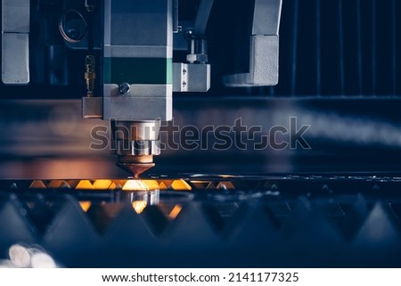 Concept technology industrial Blue color with copy space. Closeup Laser CNC cut of metal with light spark. Royalty-Free Stock Photo #2141177325