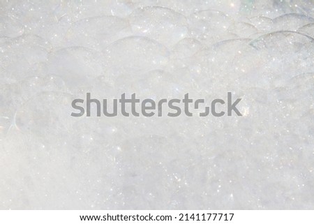 Abstract white  colors background of bokeh lights or bubbles in soft spring colors. Shampoo bubbles texture.