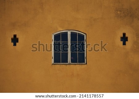 Greek style window on yellow concrete wall color Royalty-Free Stock Photo #2141178557