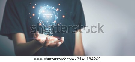 New idea and Great inspiration new beginning. concept. Hand holding digital bright light bulb  for presenting creative thinking.