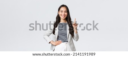 Business, finance and employment, female successful entrepreneurs concept. Good-looking confident female asian real estate broker being number one, offer good deal, showing finger and smiling Royalty-Free Stock Photo #2141191989