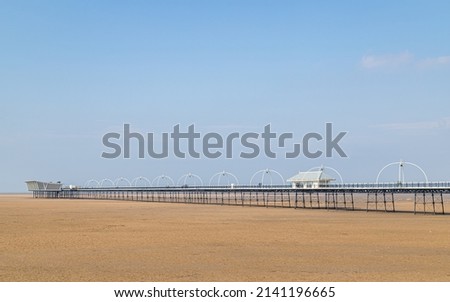 Southport Pier under a blue sky captured as an HDR image in March 2022 in Merseyside. Royalty-Free Stock Photo #2141196665