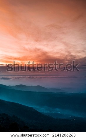 Mountains under mist in the morning Amazing nature scenery  form Munnar Kerala God's own Country Tourism and travel concept image, Fresh and relax type nature image