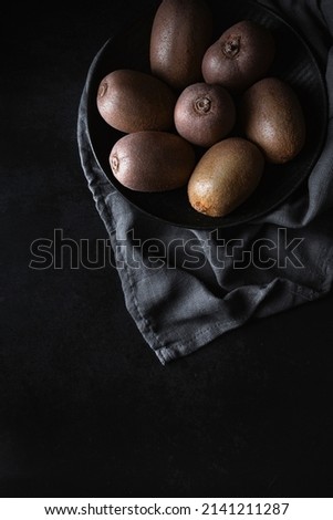 
Fresh and ripe kiwis on a dark background. Healthy food photography. Fruit rich in vitamin C