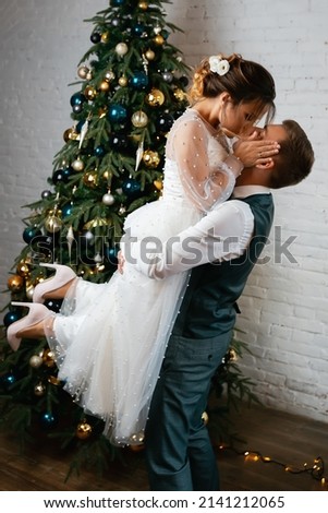 Romantic wedding couple on the background of the Christmas tree.