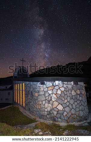 Chapel of saint Christopher on the Grimselpass in Switzerland and the milky way in the starry sky