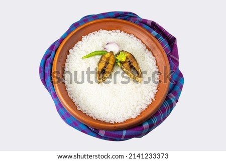ilish panta Bengali new year festive dish. Boishakh panta ilish with green chilli and onion. Panta bhat is popular among Bengali's in India and Bangladesh. with gamcha. Royalty-Free Stock Photo #2141233373
