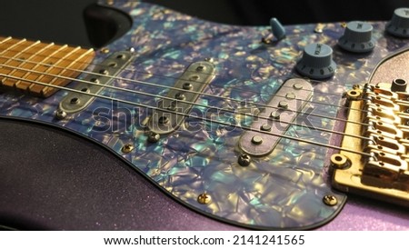 Electric guitar on a gray background.  The stratocaster is isolated on a dark background in close-up.  electric guitar pickups close-up selective focus. Vintage electric guitar.