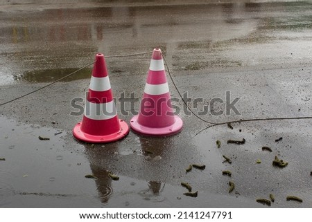 Two traffic cone on wet asphalt street road under rain