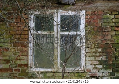 Brick wall with window in old abandoned building