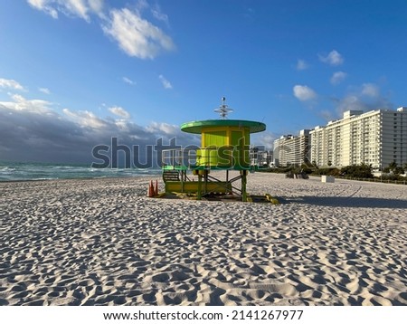 Iconic green lifeguard house in Miami Beach. Beautiful blue sky at sunrise..