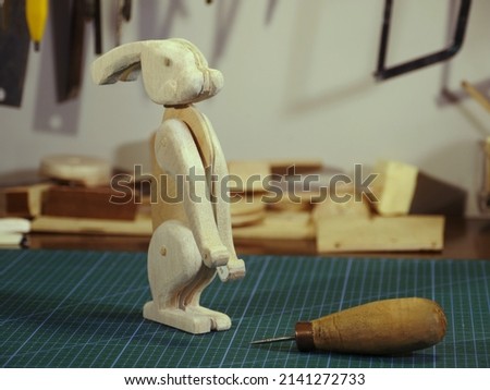 hare wooden toy on the table in the workshop