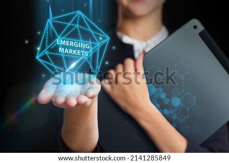 Business, Technology, Internet and network concept. Young businessman working on a virtual screen of the future and sees the inscription: Emerging markets Royalty-Free Stock Photo #2141285849