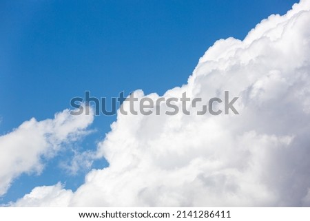 Beautiful cloudscapes, puffy, billowy, fluffy white and gray clouds against a gorgeous blue sky.  Royalty-Free Stock Photo #2141286411