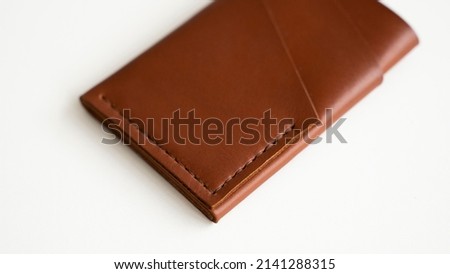 Empty men's business handmade leather card holder with isolated on white background. Selective focus, copy space, close up.