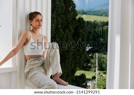 portrait of a young woman comfortable hotel luxurious green nature view sunny day