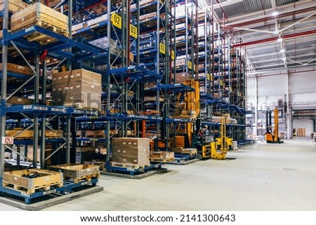 Modern warehouse interior with shelves and boxes Royalty-Free Stock Photo #2141300643