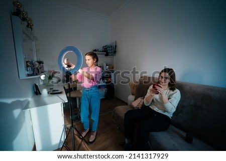 mother and daughter record video use smartphone. High quality photo