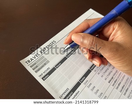 A concept image of a Black person completing a travel expense form Royalty-Free Stock Photo #2141318799