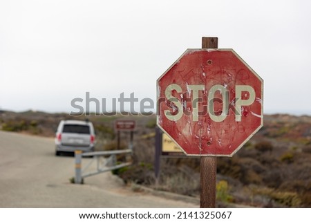 rusty stop sign on a road