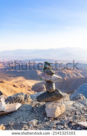 rock cairn in front of mountainous panorama