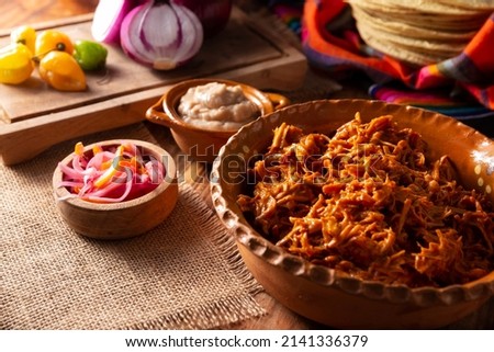 Cochinita Pibil. Typical Mexican stew from Merida, Yucatan, made from pork marinated with achiote and generally accompanied with beans and red onion with habanero chili, it can be eaten in tacos. Royalty-Free Stock Photo #2141336379