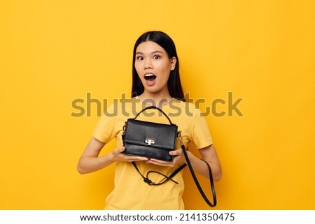 woman in yellow t-shirts fashion posing female accessory yellow background unaltered