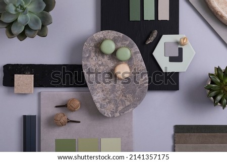 Creative architect and interior designer moodboard. Flat lay composition in grey and green color palette with textile and paint samples, panels and tiles. Top view. Copy space. Template.