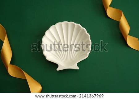 Shell Clay Plate with Green Leaf Background Aesthetic with Golden Ribbon