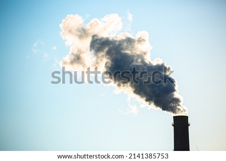 Working oil refinery. Smoke from the factory chimney. Ecological pollution. Air emissions polluting the city. Industrial waste is hazardous to health. Large factory in smog, Production in operation. Royalty-Free Stock Photo #2141385753