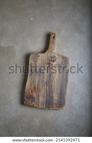 Old natural wooden cooking board with cuts