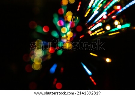 Motion blur effect of long exposure led lights. Abstract background with bokehs and bursts of light. Valentines Day, Party, Christmas, Happy New Year concept background.