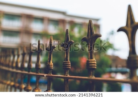 sharp-pointed steel vintage style adorned on the fence to prevent climbing Royalty-Free Stock Photo #2141396221