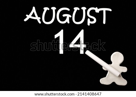 14th day of August. A small white plasticine man writing the date 14 August on a black board. Business concept. Education concept. Summer month, day of the year concept.
