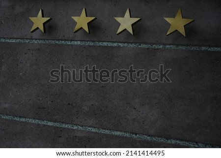 golden Board or signboard for a four stars hotel. 4 stars hotel signage board. Wall of a building with a sign for a hotel with star declaration