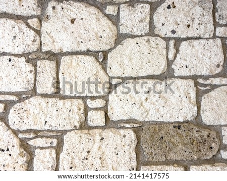 Geometric shaped stone wall texture. Part of old rocky hand crafted background with copy space. Walls made of natural bricks. High quality photo. Home and office design backdrop