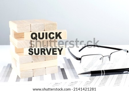 QUICK SURVEY is written on a wooden blocks on a chart background