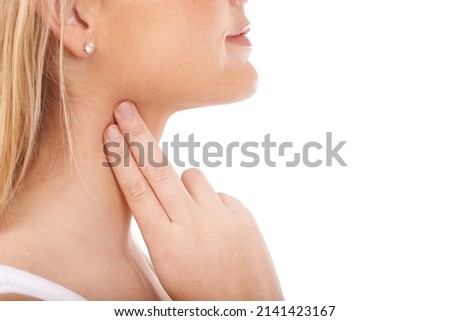 Monitoring her pulse rate carefully. Young woman taking her pulse rate against a white background. Royalty-Free Stock Photo #2141423167