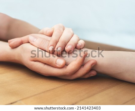 All will be fine. Cropped shot of two people holding hands in comfort. Royalty-Free Stock Photo #2141423403