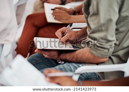 Keep notes of how far you are towards your goals. Closeup shot of an unrecognisable businessman writing notes during a conference.