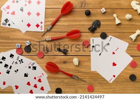 Different board games on wooden background, top view.