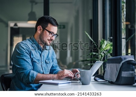 Hardworking executive, browsing the internet for information. Royalty-Free Stock Photo #2141433263