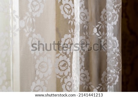 Decorative curtains are made in light warm colors.Interior.Background photo.Vintage.